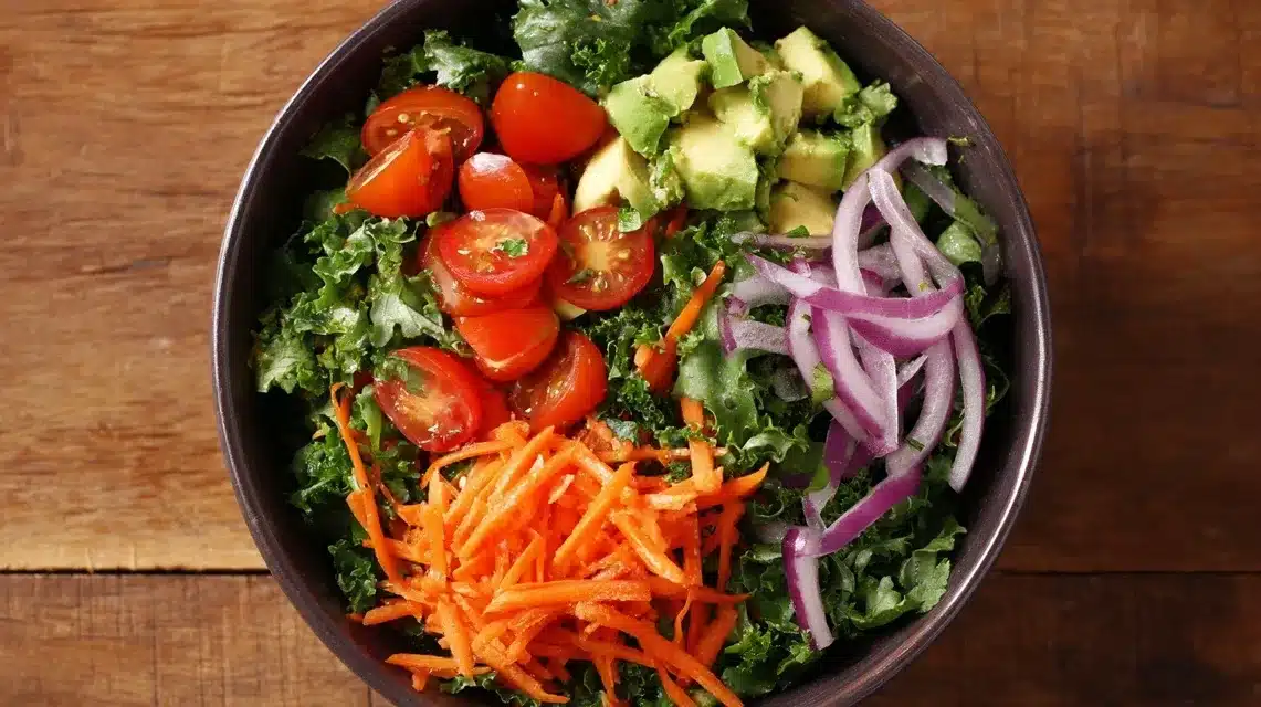 Chicken tender salad topped with avocado, tomatoes, and carrots