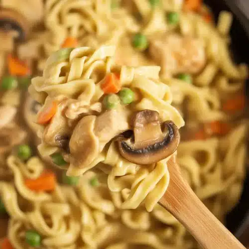 Creamy Chicken Pot Pie With Egg Noodles in a skillet dish, showcasing rich flavors.