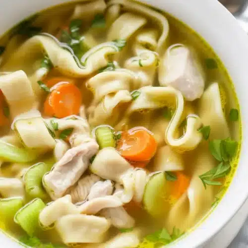 Delicious homemade Chicken Noodle Soup with chicken, veggies, and flavorful broth.