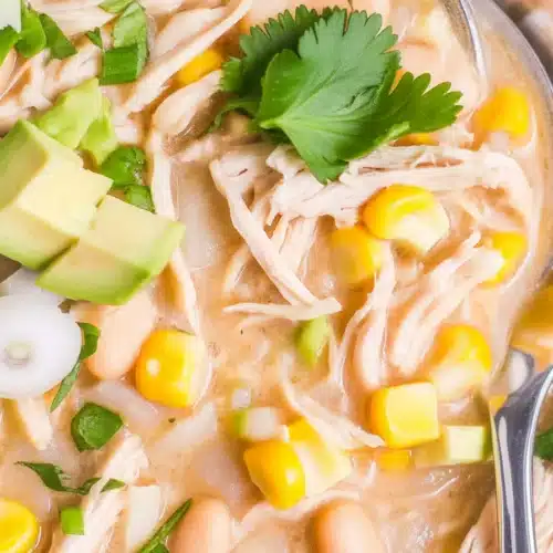 Delicious Instant Pot White Chicken Chili topped with green onions and served in a bowl.